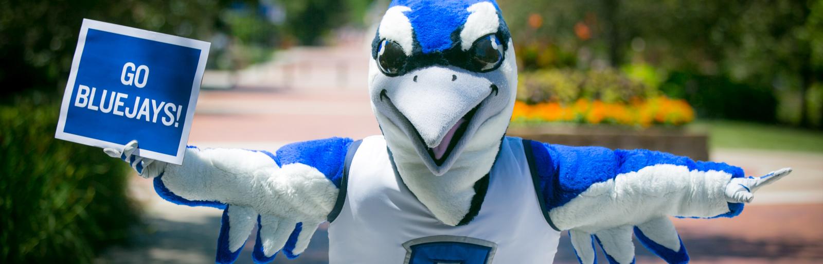 Mascot Billy Bluejay from Creighton University holding a Go Bluejays sign